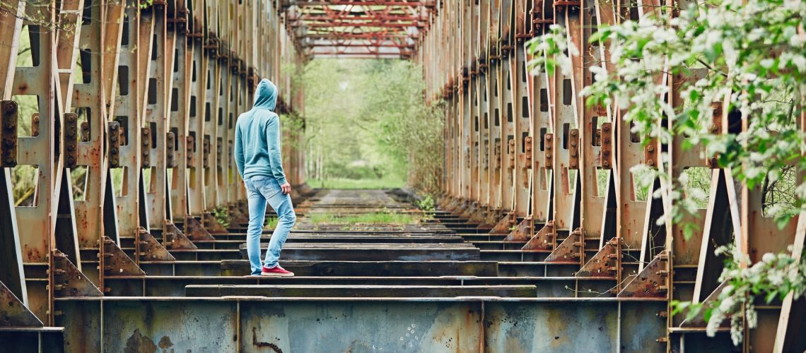 Sad man on the abandoned bridge